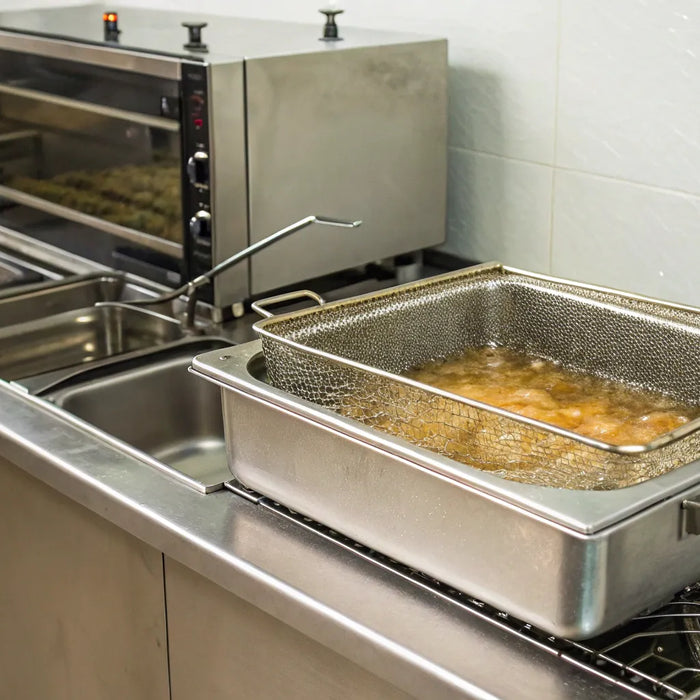 Essential fast food cooking equipment, including a commercial deep fryer and oven.