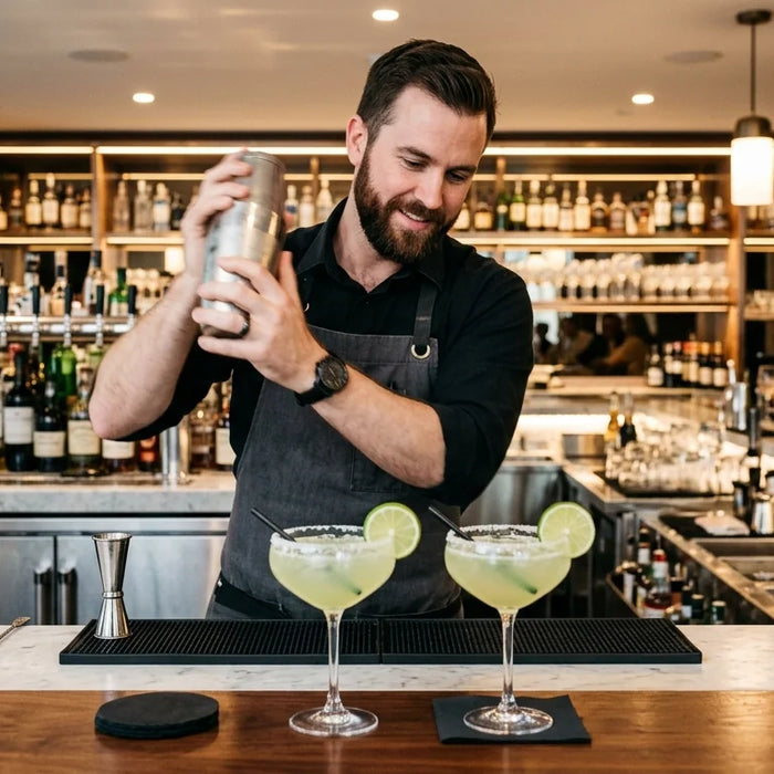 Professional bartender shaking a margarita in a high-end commercial bar setting