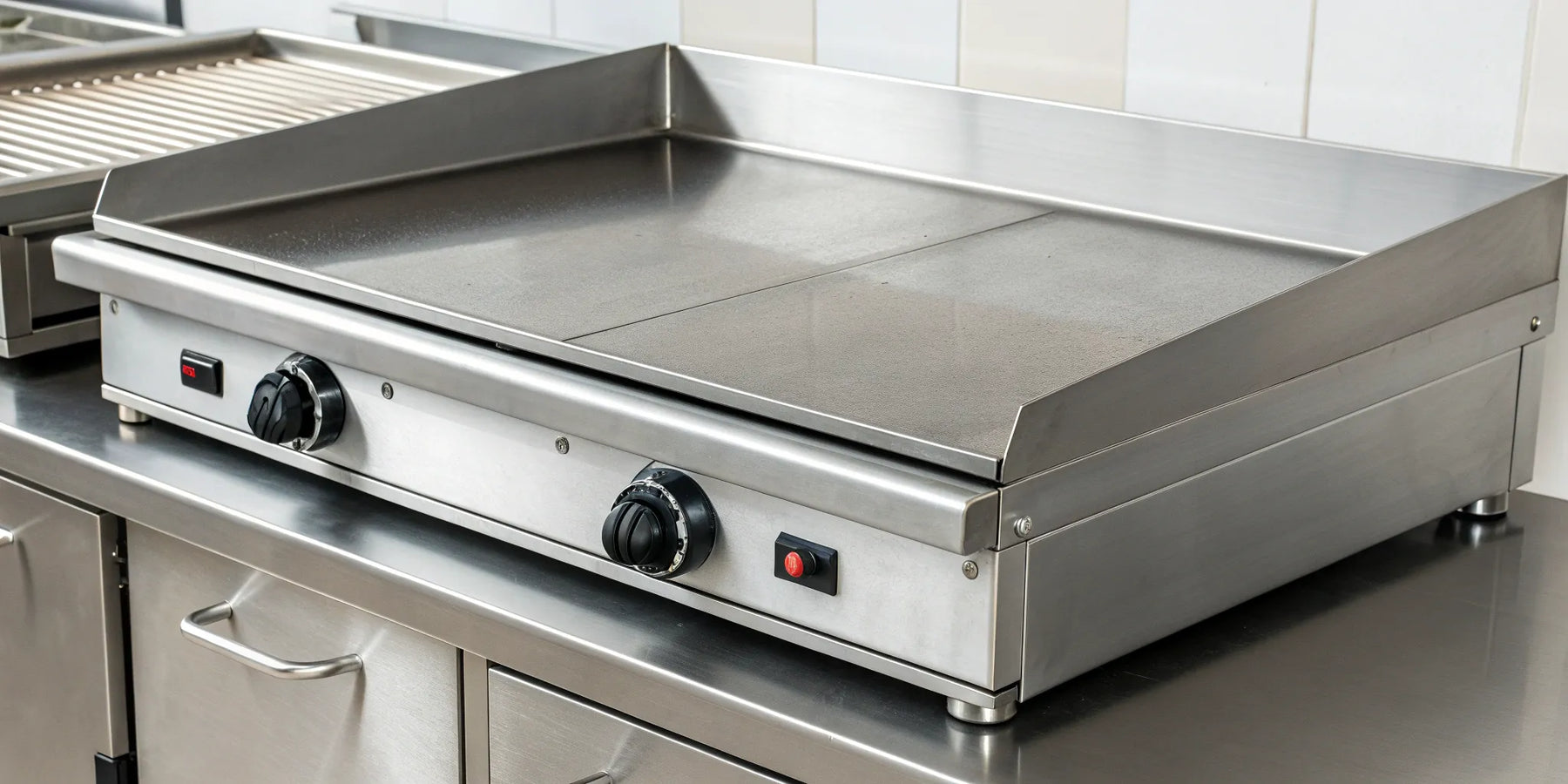 Large, commercial-grade electric griddle with a stainless steel surface and dual controls.