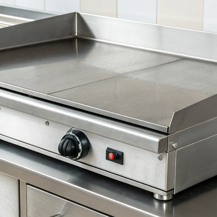 Large, commercial-grade electric griddle with a stainless steel surface and dual controls.