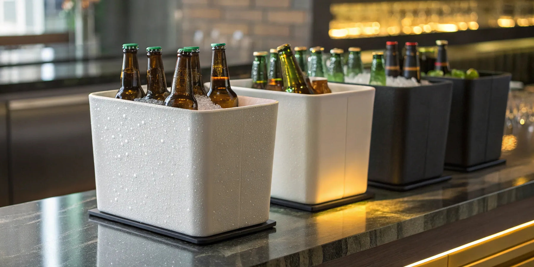 Different types of beer bottle coolers filled with ice on a bar.