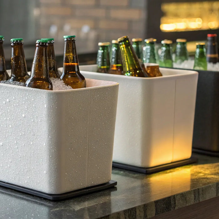 Different types of beer bottle coolers filled with ice on a bar.