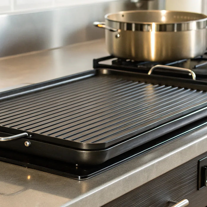 A commercial stainless steel electric grill griddle on a kitchen counter.