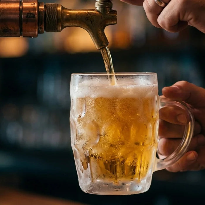 A close-up shot shows a bartender pouring beer into a heavily frosted glass mug.