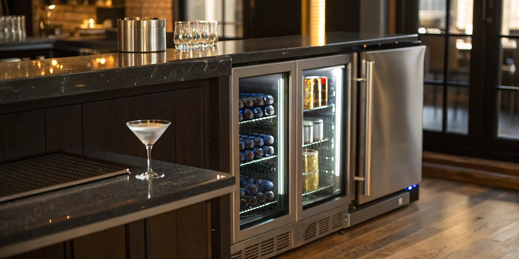Undercounter bar refrigerator with glass door displaying beverages.