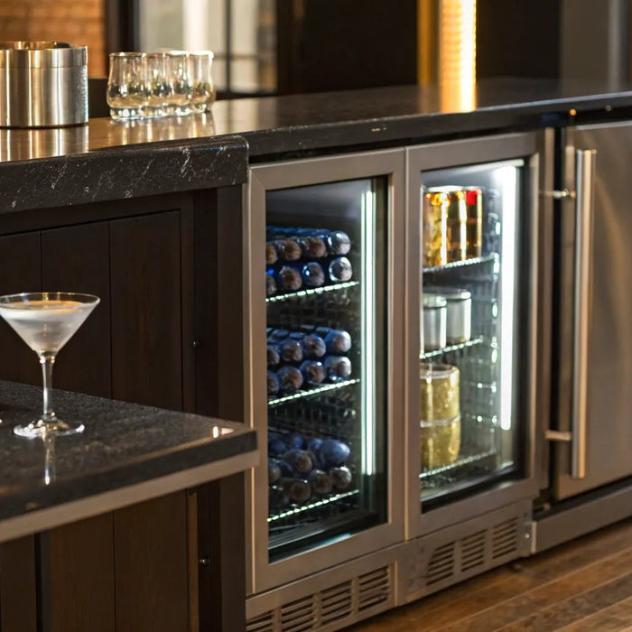 Undercounter bar refrigerator with glass door displaying beverages.