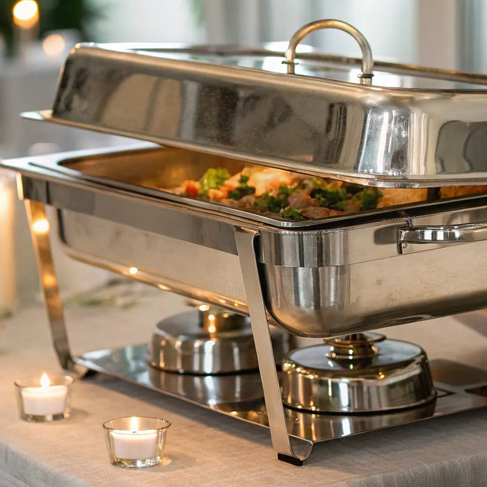 Chafing dish with lid open on a buffet table.