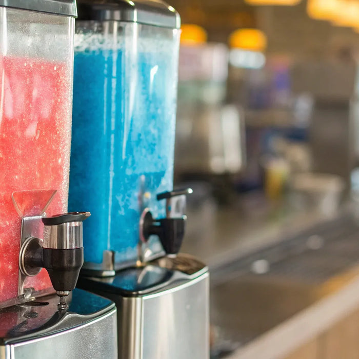Red and blue slushies in a commercial slushy machine.