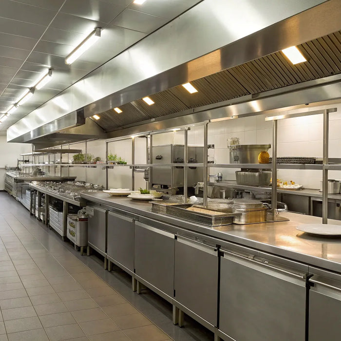 Commercial restaurant kitchen with essential cooking and prep equipment.