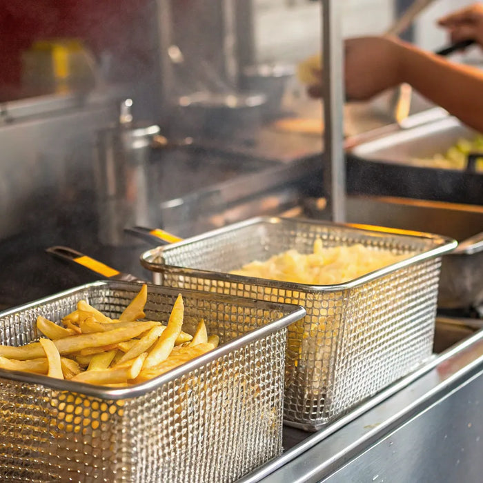 Food truck fryer basket of french fries.
