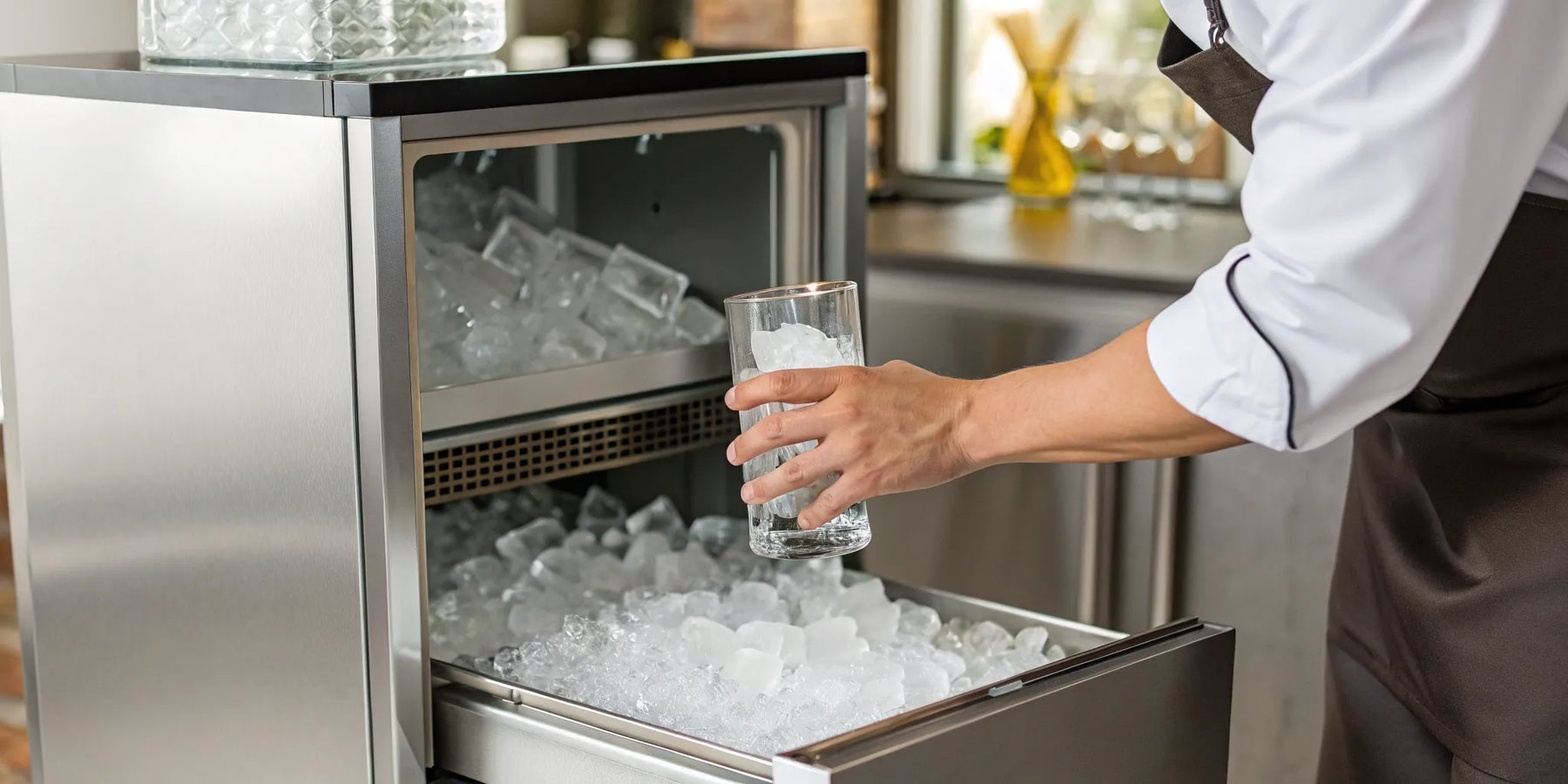 Commercial ice maker dispensing ice into glass.