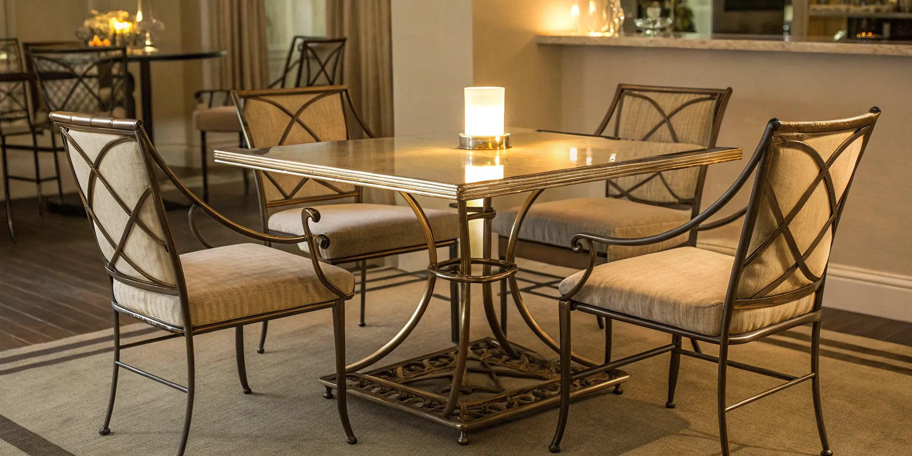 A modern metal dining table and chairs set with cushioned seats.