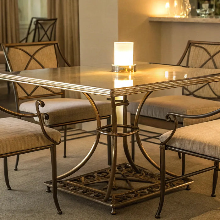 A modern metal dining table and chairs set with cushioned seats.