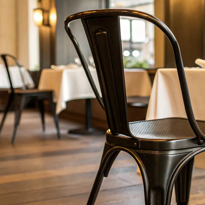 Sleek metal black chair in a restaurant setting.