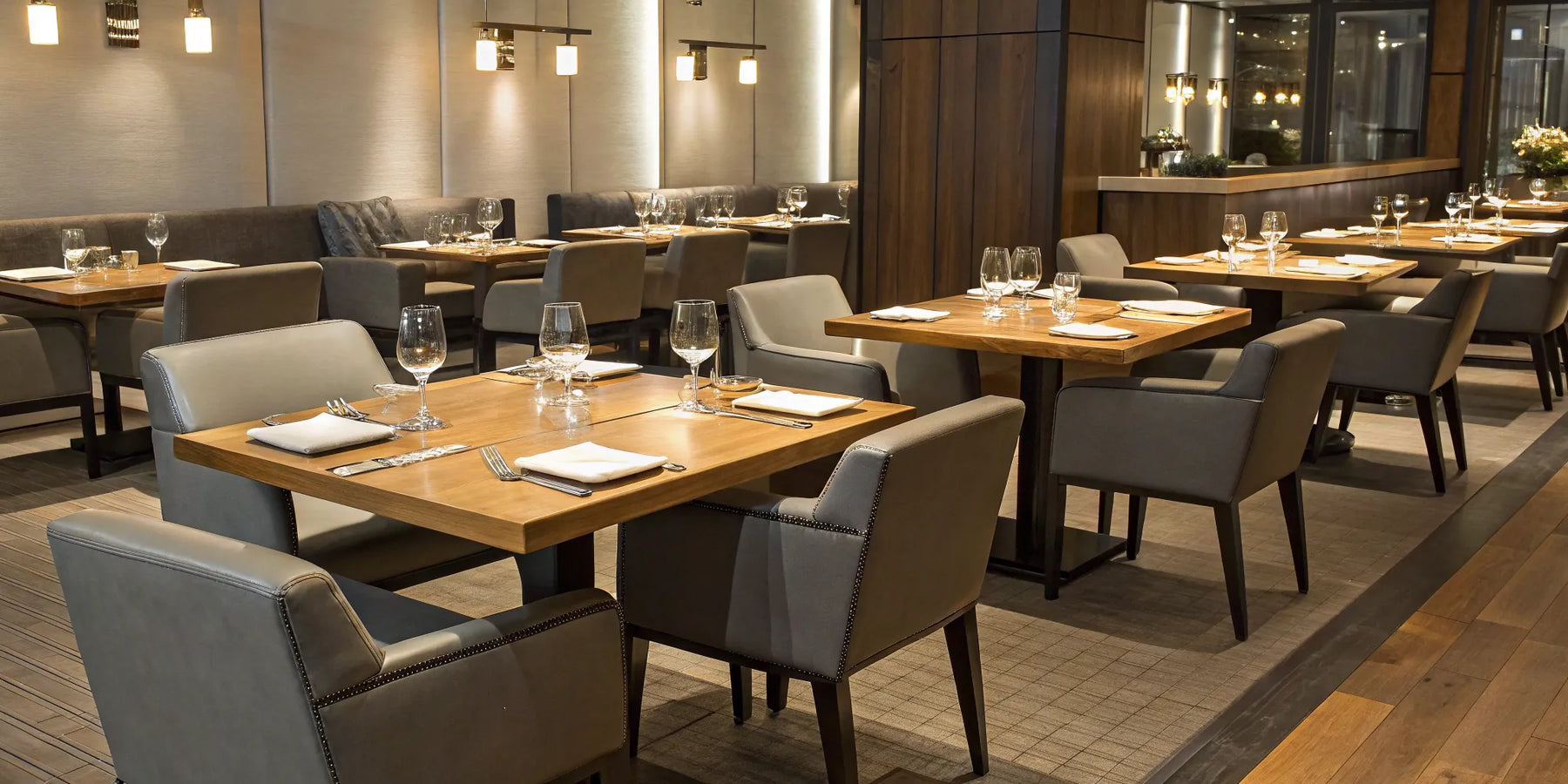 Restaurant furniture: Tables, chairs, and table settings.