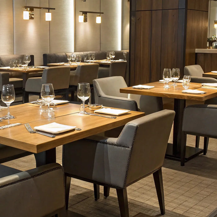 Restaurant furniture: Tables, chairs, and table settings.