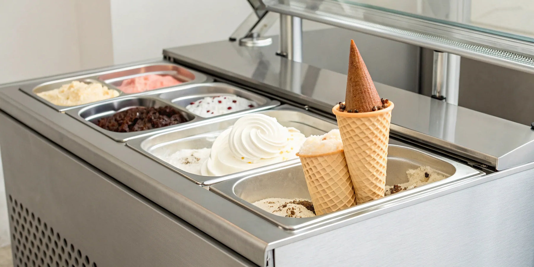 A professional Italian ice cream machine with trays of colorful gelato.