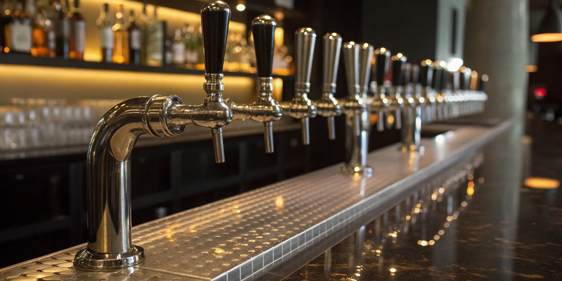 A collection of liquor pourer spouts on bottles at a bar.