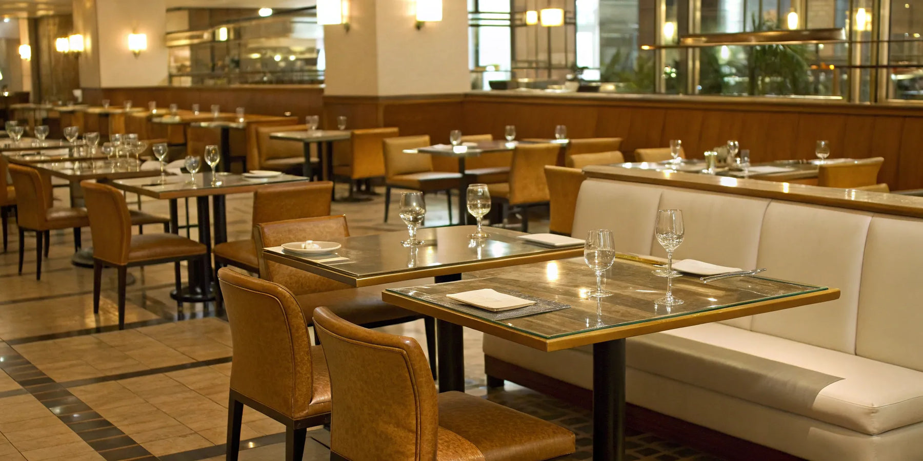 A variety of commercial tables and chairs in a modern restaurant dining room.