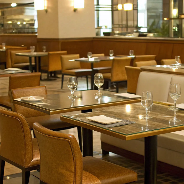 A variety of commercial tables and chairs in a modern restaurant dining room.