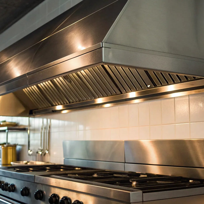 A stainless steel restaurant hood installed in a commercial kitchen for proper ventilation and safety.