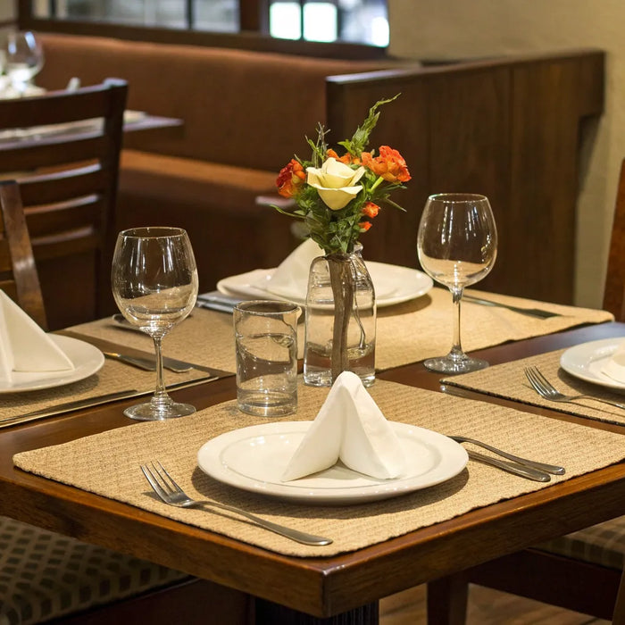 Stylish restaurant dining set with wooden chairs and elegant tableware.