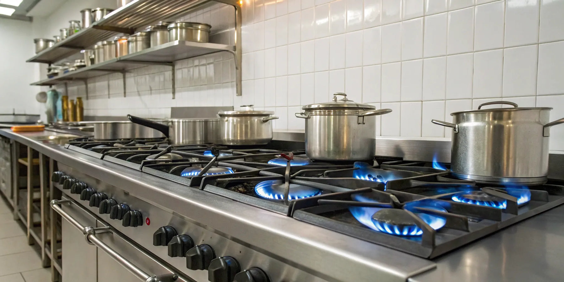 Commercial gas range with blue flames.