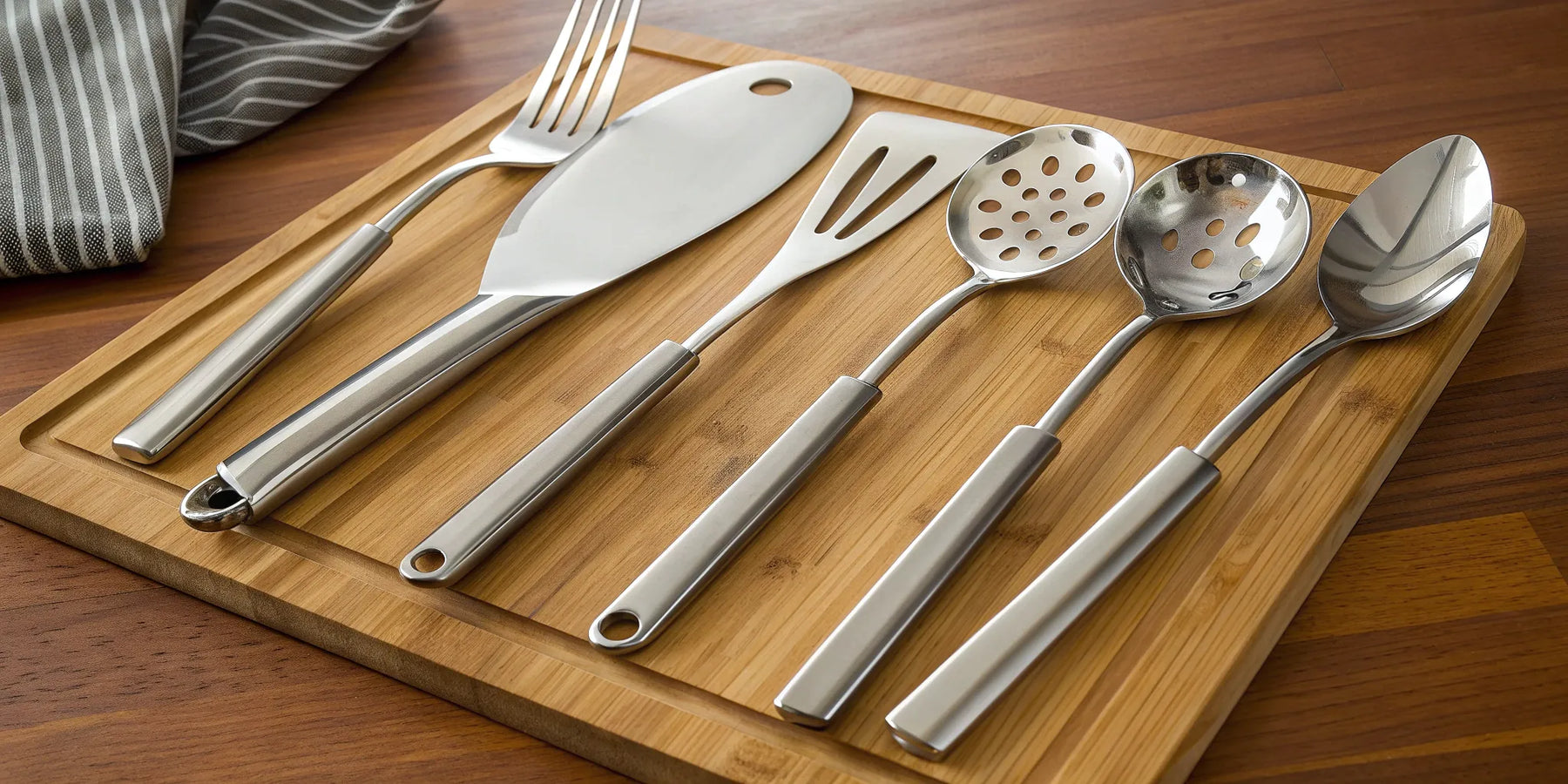 A set of high quality kitchen utensils in stainless steel for a professional kitchen.