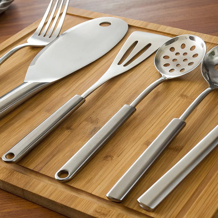 A set of high quality kitchen utensils in stainless steel for a professional kitchen.