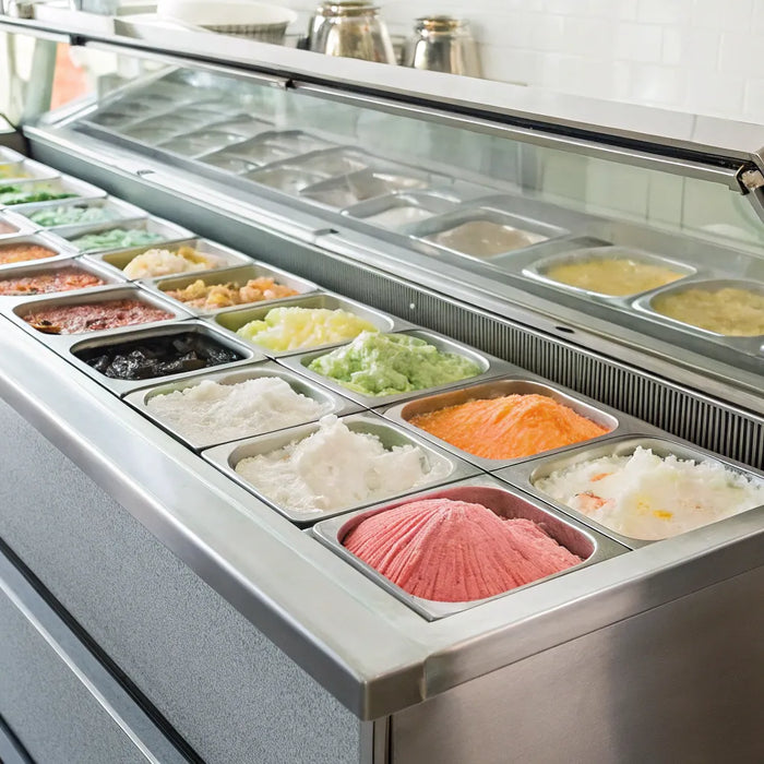 Commercial ice cream fridge displaying colorful flavors in a modern shop.
