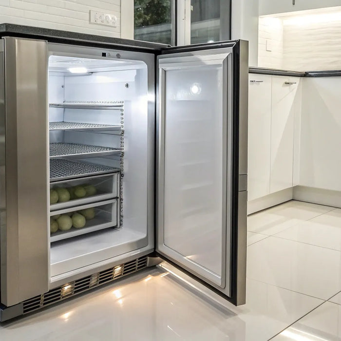 A commercial undercounter freezer with its stainless steel door open, showing the interior shelves.