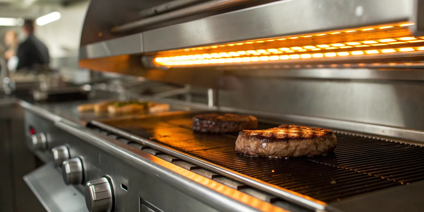 Salamander broiler searing steaks in a commercial kitchen.