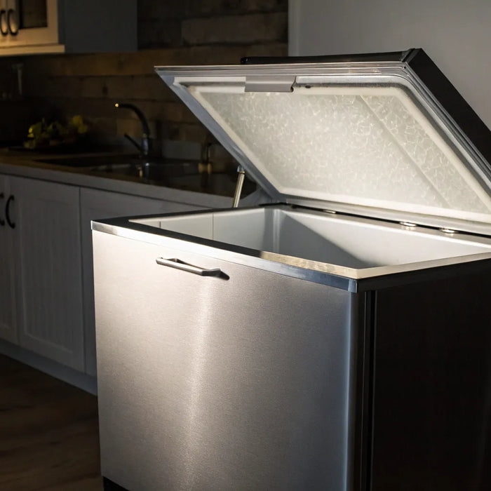 An open chest freezer with auto defrost technology in a kitchen.