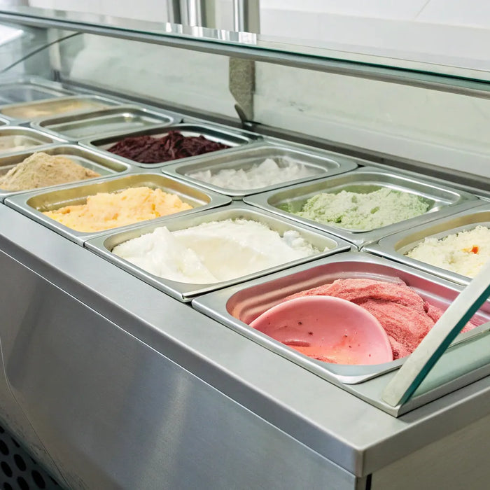 Commercial ice cream display freezer for sale with tubs of colorful ice cream.