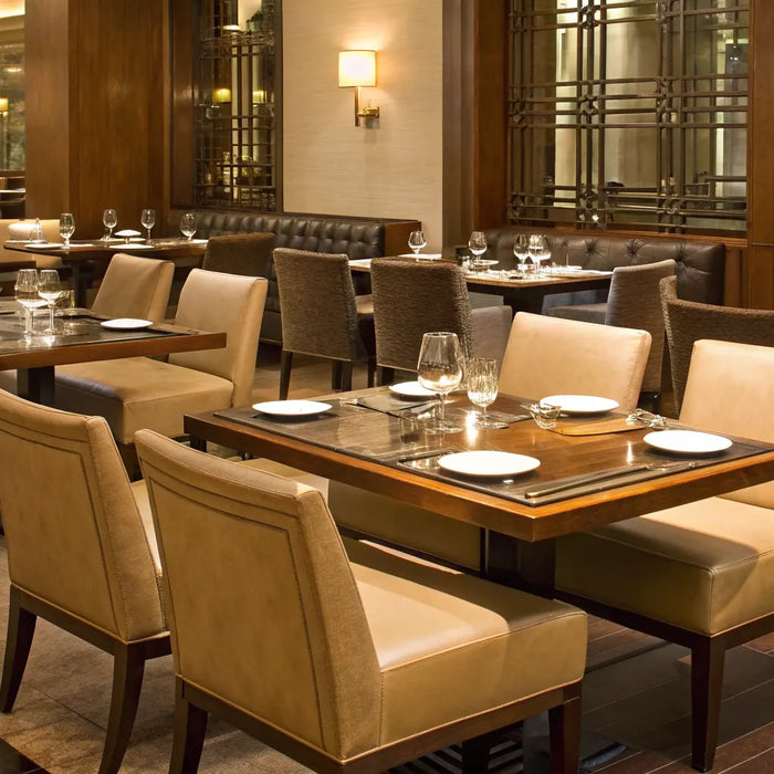 Modern restaurant chairs and tables for sale set up for a commercial dining room.