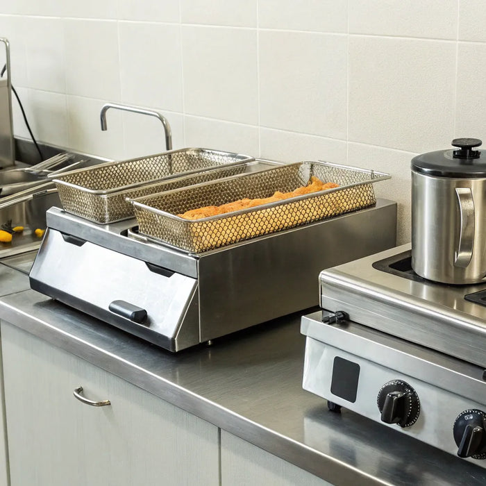 Essential fast food equipment for a commercial kitchen, including a deep fryer and prep station.